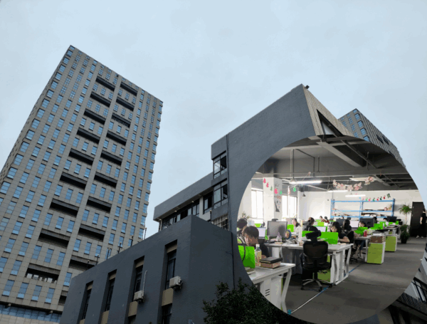 Modern office building exterior with interior view of employees working at desks.
