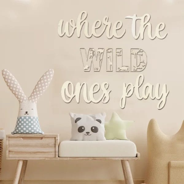 Wooden wall decor: "Where the Wild Ones Play," featuring animal cutouts. Nursery room setting.